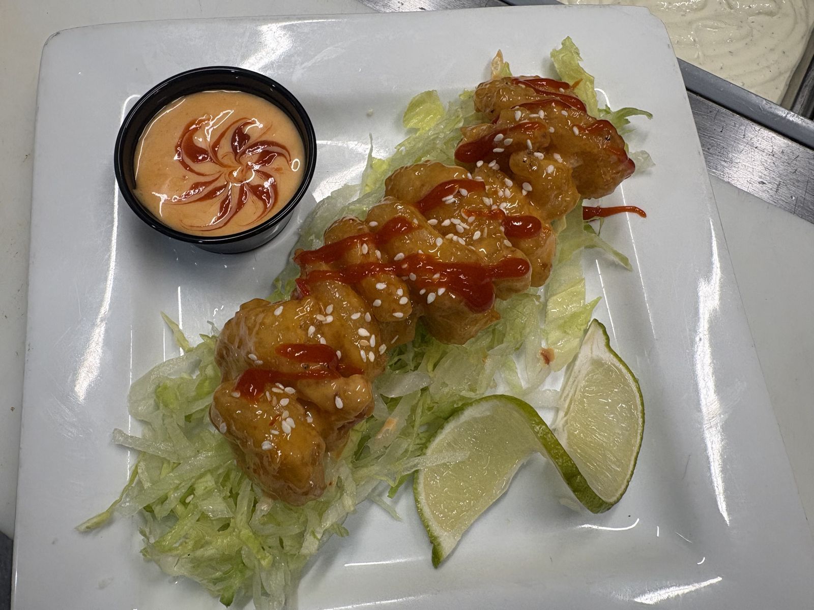 Bang bang shrimp over lettuce with lime